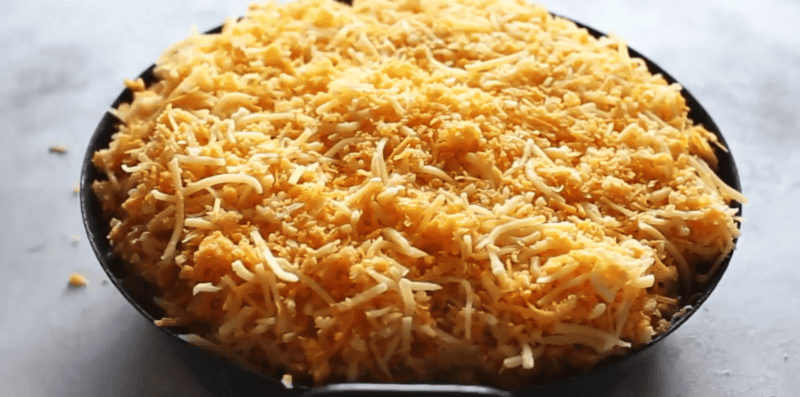 chopping enchilada dip with cheese