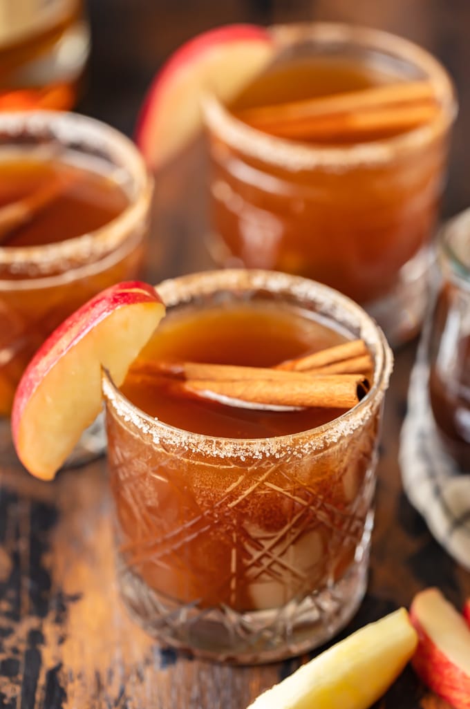 An old fashioned cocktail with apple cider, cinnamon, and apples.