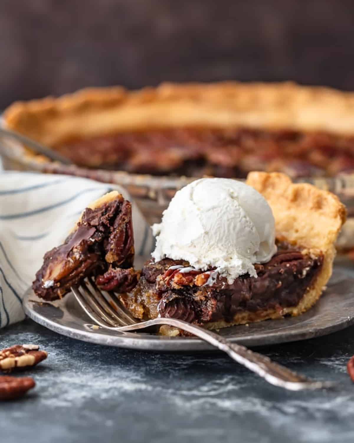 Pecan pie with chocolate on a plate.