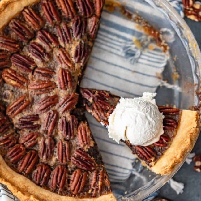 Chocolate Pecan Pie is the perfect mix of pecan and chocolate pies. Chocolate filling made with chocolate chips and bourbon, topped with toasted pecans. This Chocolate Bourbon Pecan Pie recipe needs to be added to your holiday dessert table as soon as possible. Make it for Thanksgiving, Christmas, or any time you wan this delicious pie!