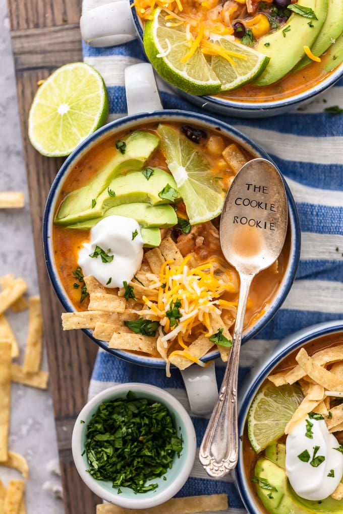 Bowls of chicken tortilla soup on a blue and white striped dish towel