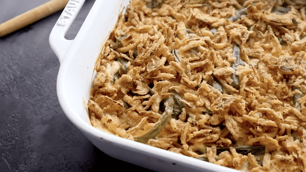 green bean casserole topped with crunchy onions in a baking dish.