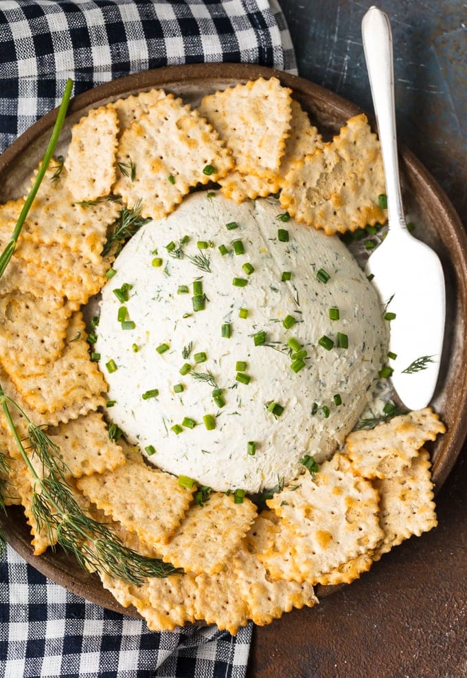 Herb Cream Cheese Dip on a serving plate, surrounded by crackers