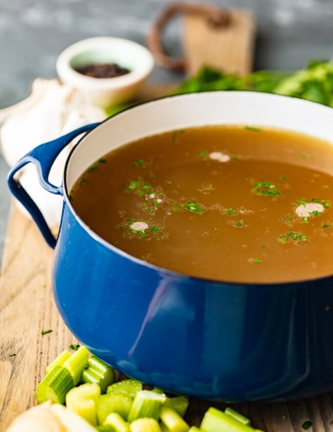 Homemade Chicken Broth is so easy to make, you won't need to buy it from the store anymore. This delicious chicken broth recipe is made with lots of vegetables, spices, and chicken to create the perfect flavor. Learn how to make chicken broth and use it in all of your soups this winter season!