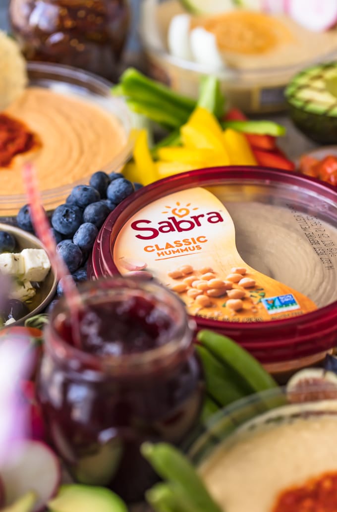 The Ultimate Hummus and Vegetable Board is easier to throw together than you might think! This beautiful spread of Hummus, Summer Veggies, and more is sure to please even the pickiest crowd, and it's healthy as well! So much flavor on this Hummus Board!