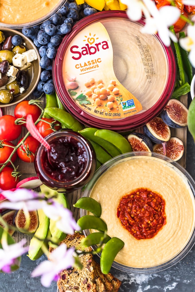 The Ultimate Hummus and Vegetable Board is easier to throw together than you might think! This beautiful spread of Hummus, Summer Veggies, and more is sure to please even the pickiest crowd, and it's healthy as well! So much flavor on this Hummus Board!