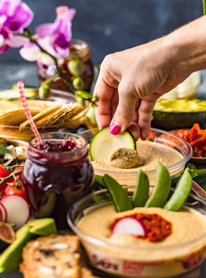 The Ultimate Hummus and Vegetable Board is easier to throw together than you might think! This beautiful spread of Hummus, Summer Veggies, and more is sure to please even the pickiest crowd, and it's healthy as well! So much flavor on this Hummus Board!