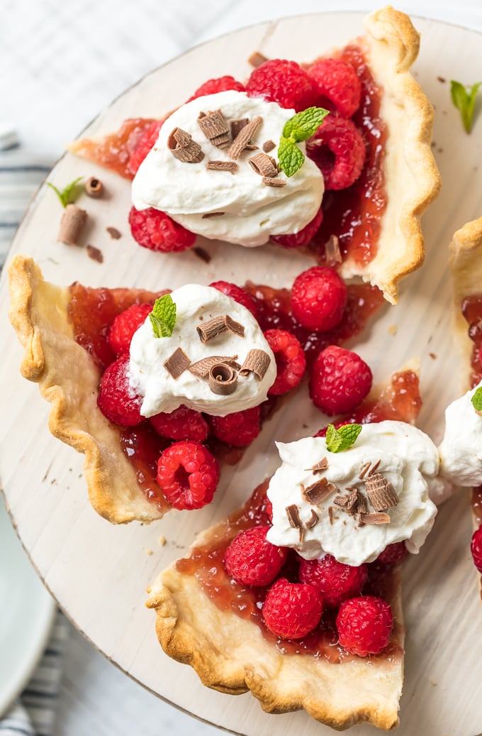 Raspberry tarts made with raspberry jam, fresh raspberries, and whipped topping
