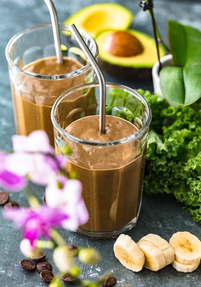 chocolate smoothies on a table of veggies and fruit