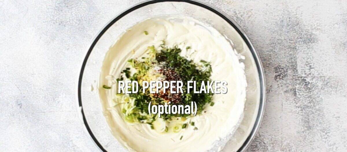 Adding the seasoning to the cream cheese mixture.