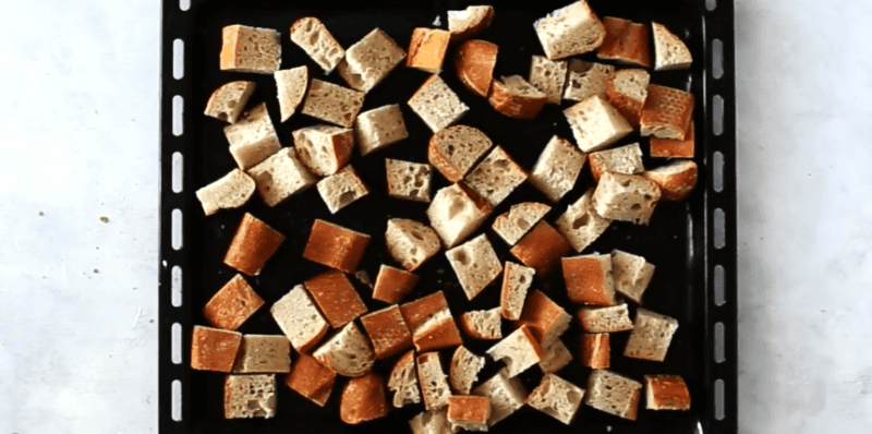 bread cubes on cookie sheet.
