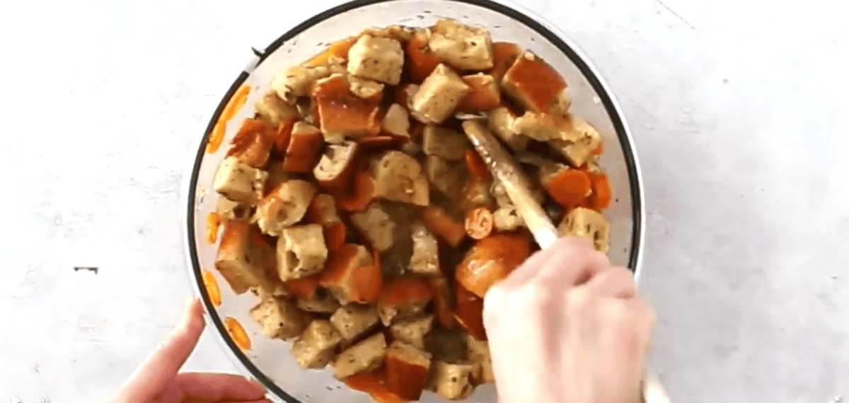mixing bread cubes, veggies, broth, breadcrumbs, butter and spices in a bowl