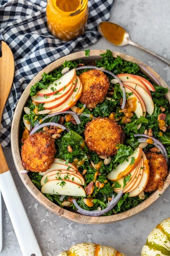 Autumn Kale Salad Recipe topped with apples and fried goat cheese