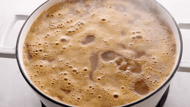 A creamy chicken tortilla soup with steam coming out of it.