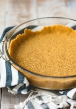 Graham Cracker Crusts add such a fun flavor and texture to cheesecakes and pies. This homemade graham cracker crust recipe is so easy to make, and doesn't require any baking. It's perfect for no bake desserts and makes for a special holiday treat!