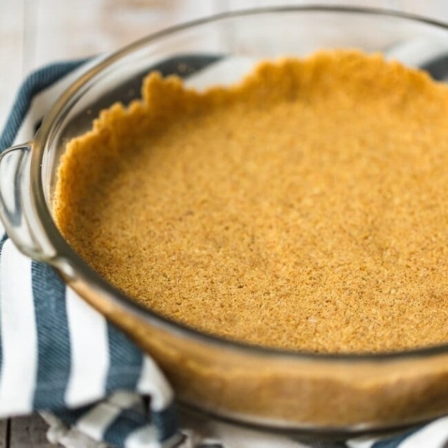 Graham Cracker Crusts add such a fun flavor and texture to cheesecakes and pies. This homemade graham cracker crust recipe is so easy to make, and doesn't require any baking. It's perfect for no bake desserts and makes for a special holiday treat!