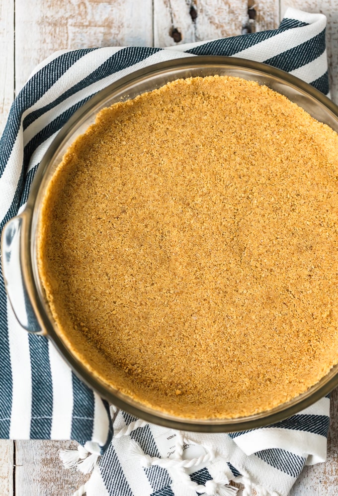 homemade graham cracker crust in a pie plate, viewed from above