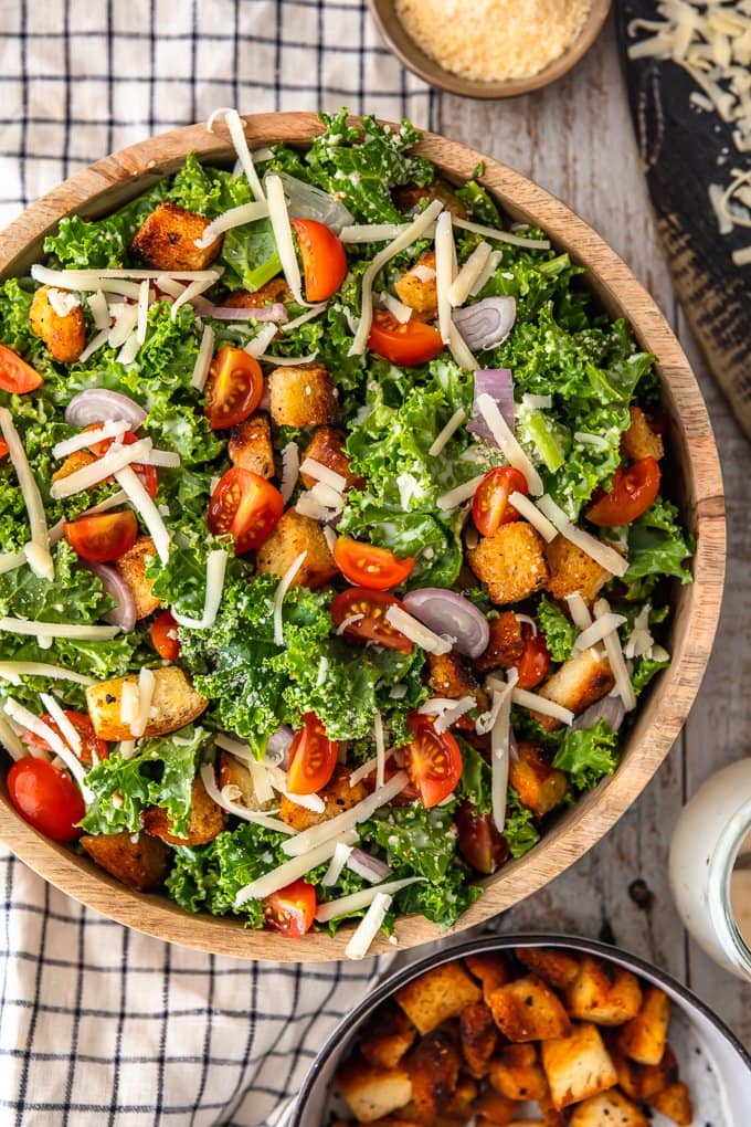 A large bowl filled with kale caesar salad, viewed from above