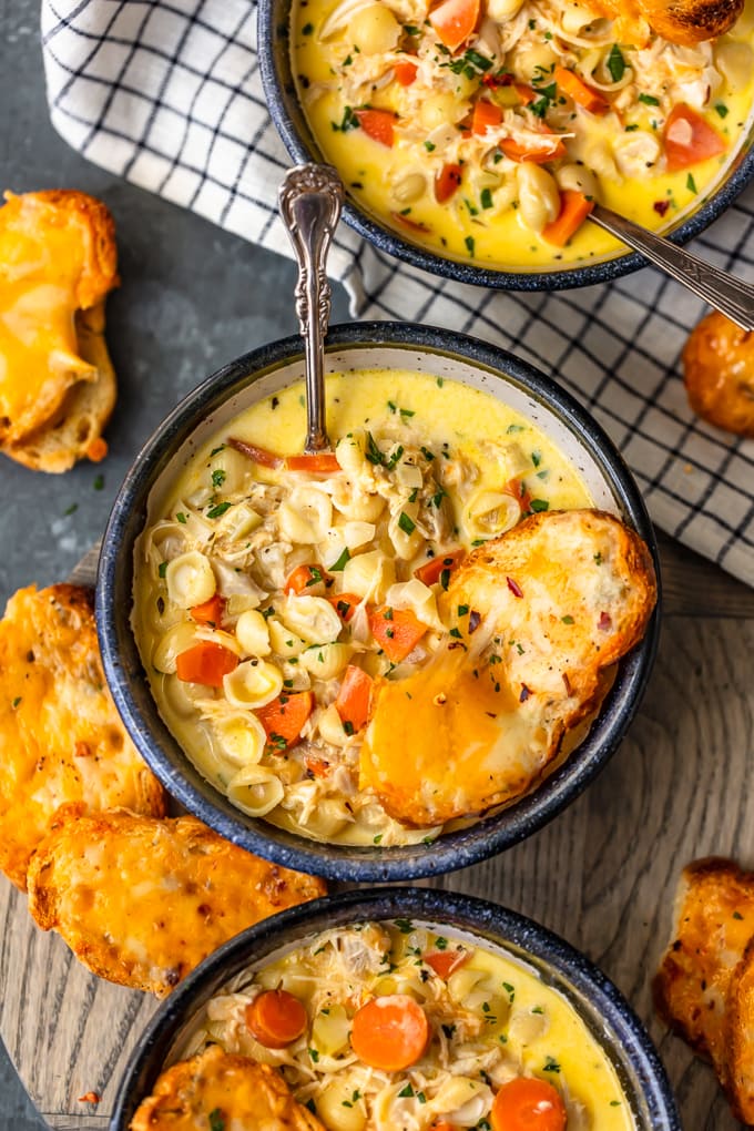 Bowls of cheesy macaroni soup with cheesy crostini