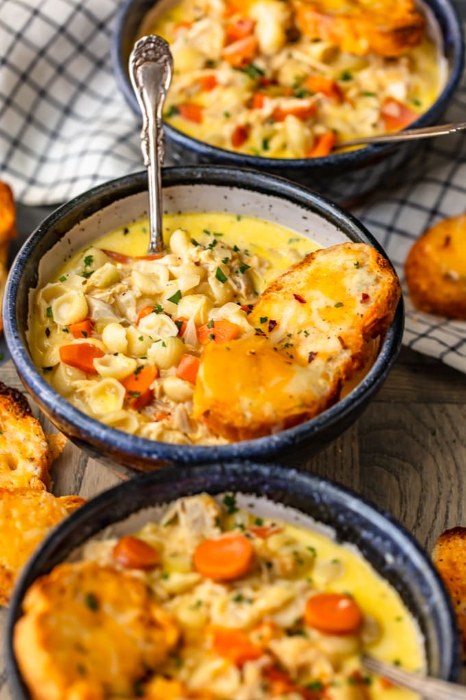 Three bowls of cheesy macaroni soup