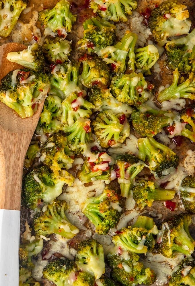 broccoli on a dish with wooden spoon