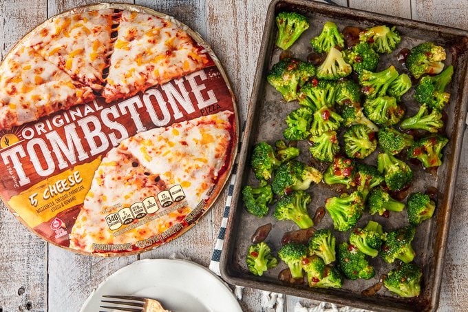 sheet pan of broccoli next to tombstone frozen pizza