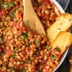 This White Beans recipe is so simple, yet so delicious! Cannellini beans cooked with tomatoes, garlic, and chicken broth make for one tasty side dish. It's perfect for holidays or easy weeknight meals!