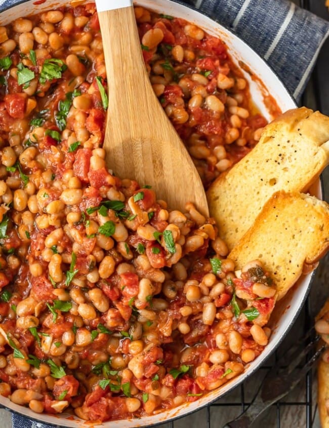 This White Beans recipe is so simple, yet so delicious! Cannellini beans cooked with tomatoes, garlic, and chicken broth make for one tasty side dish. It's perfect for holidays or easy weeknight meals!