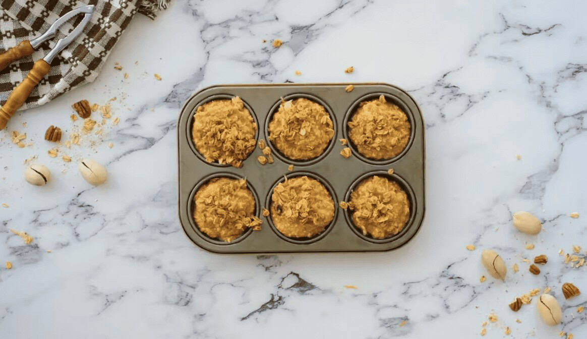 Morning glory muffin batter in a 6 cup muffin tray.