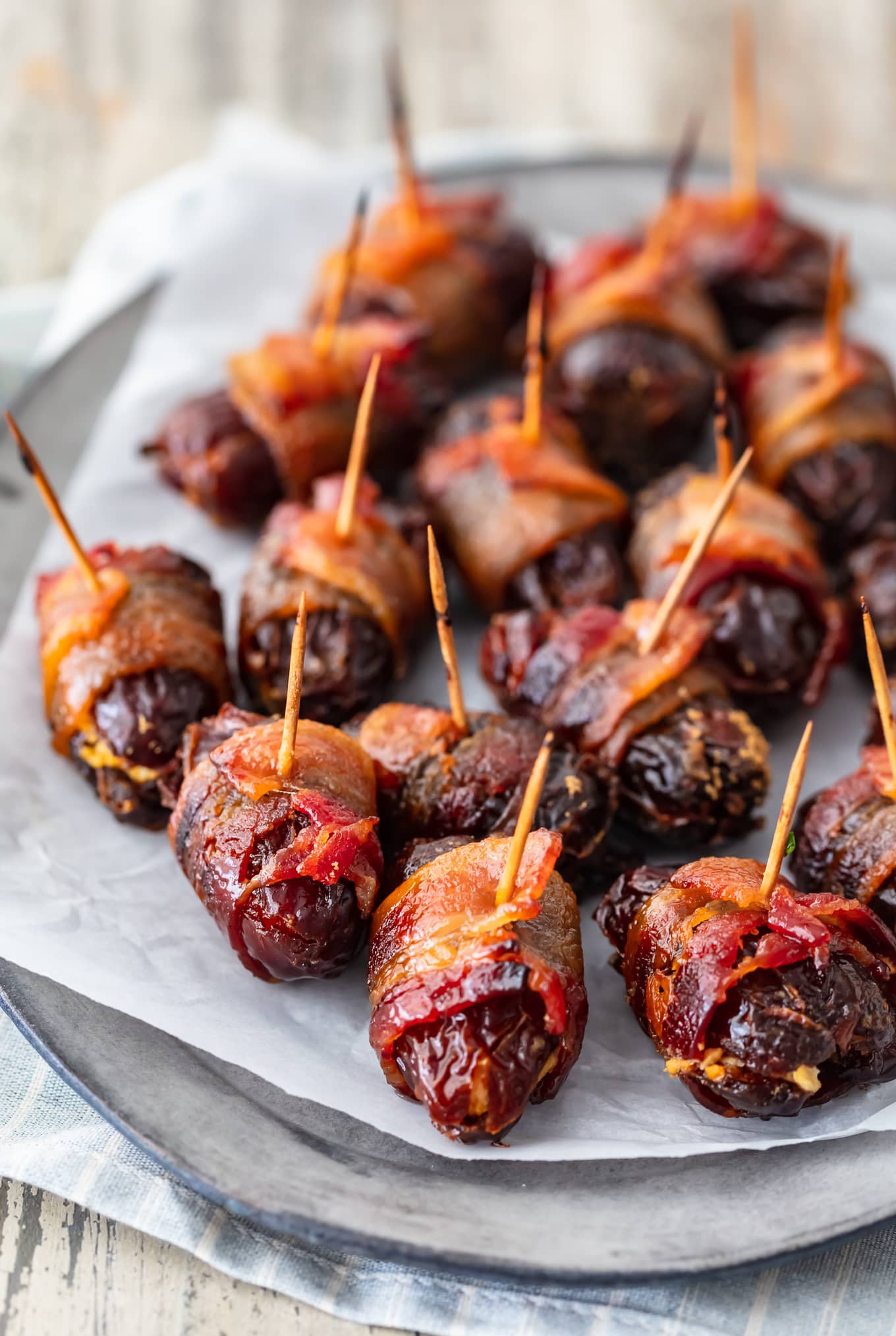 dates wrapped in bacon on a plate