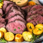 sliced beef tenderloin and potatoes on a plate