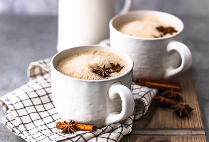 two mugs of chai tea on a dish towel