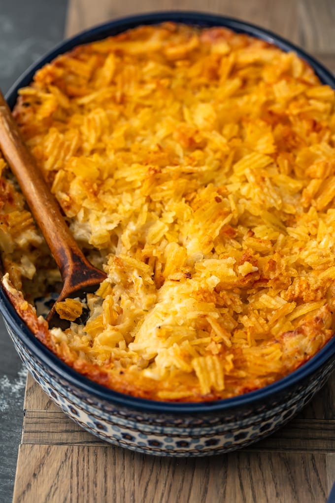 blue casserole dish filled with cheesy potatoes