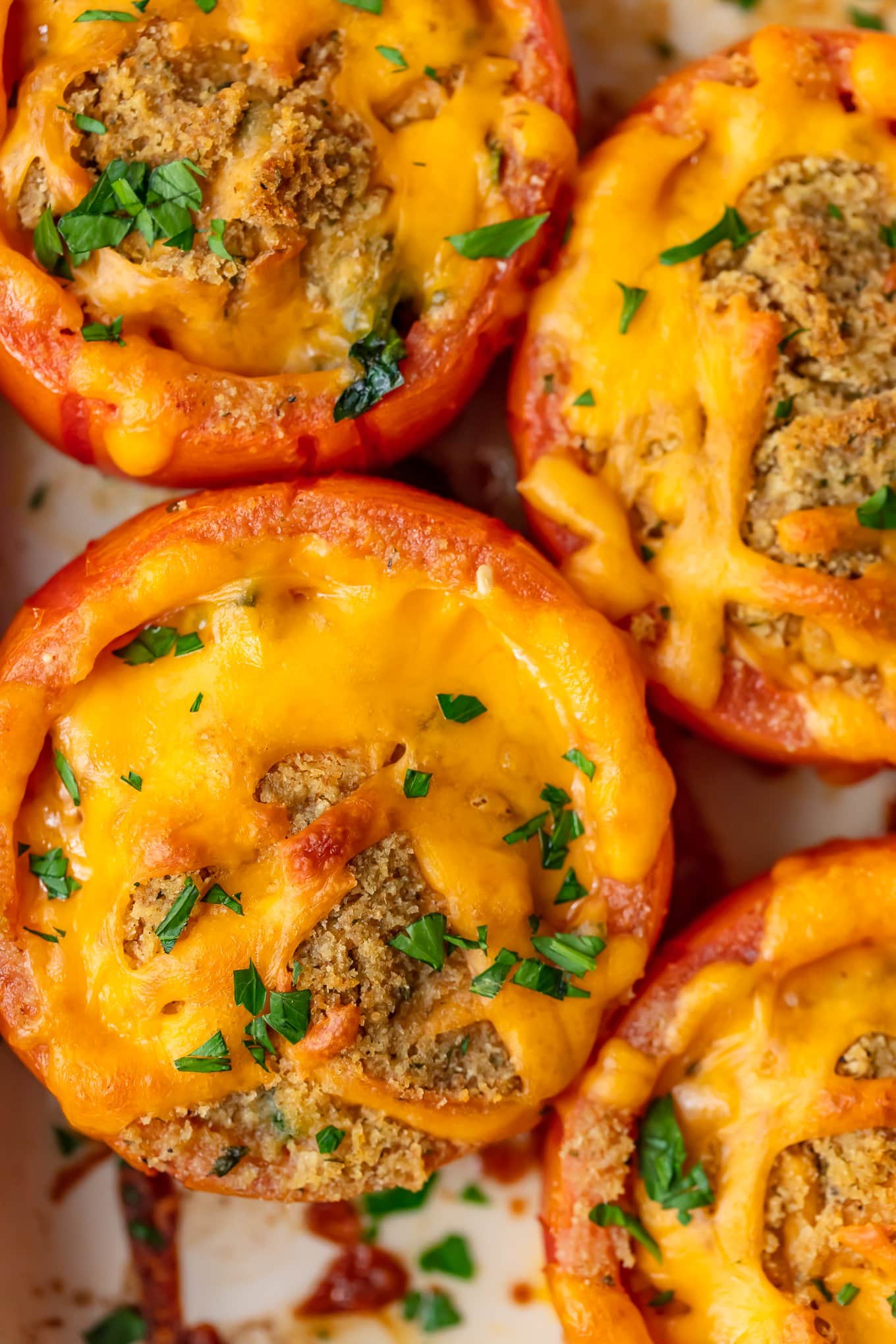 close up of the top of tomatoes with cheese on top