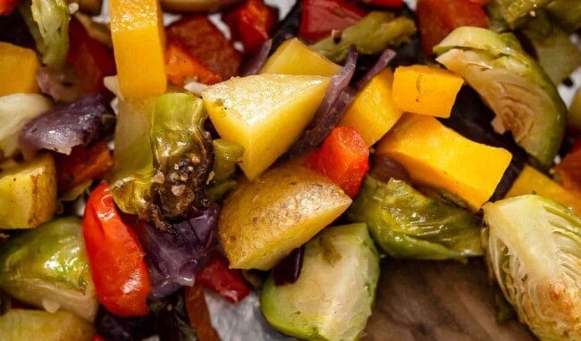 close up view of chopped roasted vegetables on a pan