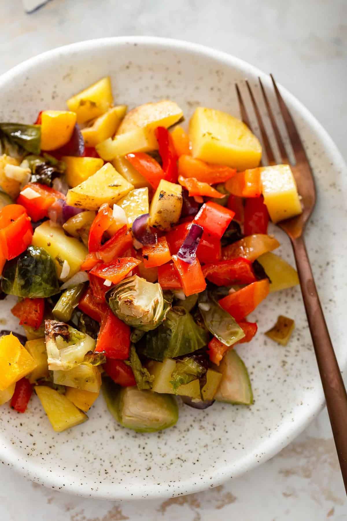 cooked brussels sprouts, squash, potatoes on a plate