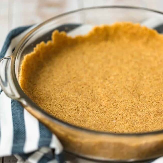 A savory pumpkin pie in a glass dish on a table.