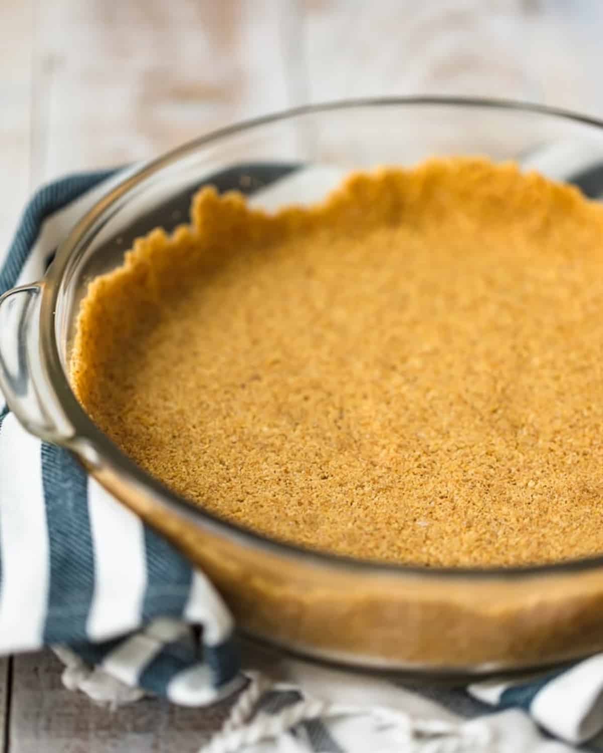 A savory pumpkin pie in a glass dish on a table.