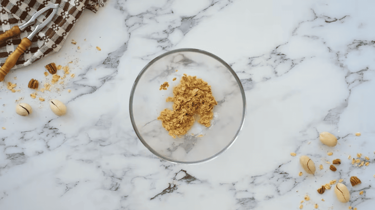 A bowl of granola and nuts on a marble table, perfect for a filling and nutritious breakfast.