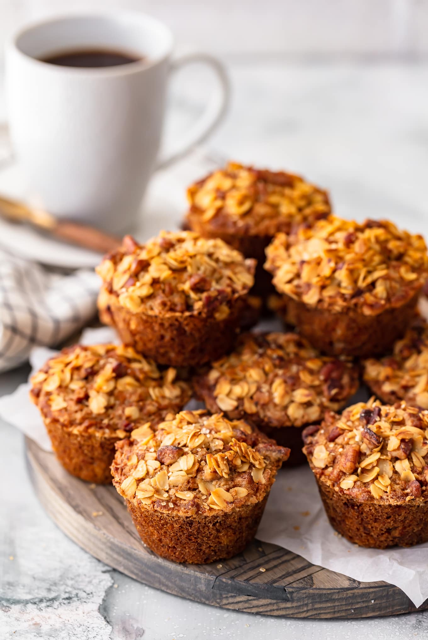 breakfast muffins arranged in a stack, next to a cup of coffee
