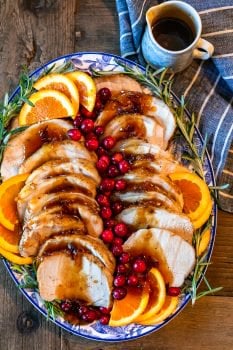 This Pork Loin Roast recipe is the perfect holiday main dish! This Orange Cranberry Pork Loin Roast is juicy, delicious, and super festive. Add this roasted pork recipe to your Thanksgiving and Christmas tables!
