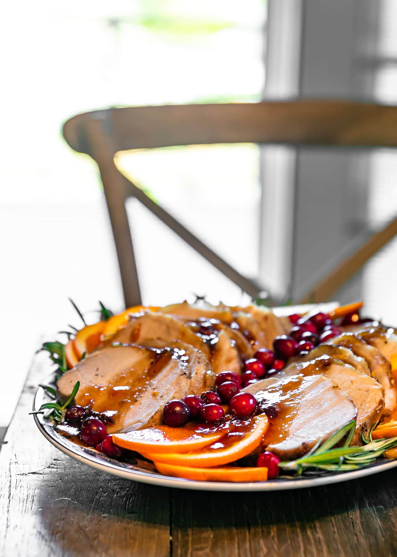 pork loin roast on a table, with a dining chair in the background