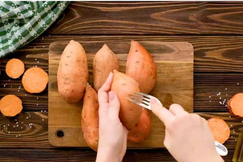poking sweet potatoes with fork