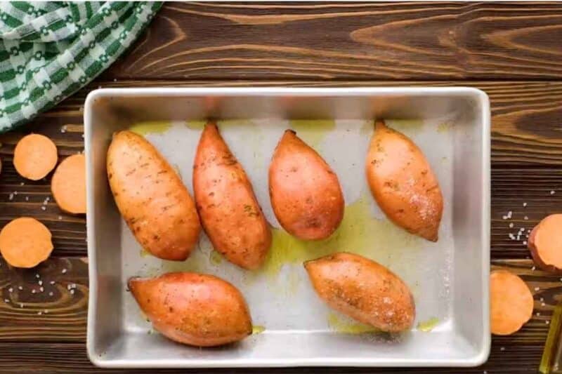 sweet potatoes in baking sheet, sprinkle some salt before baking