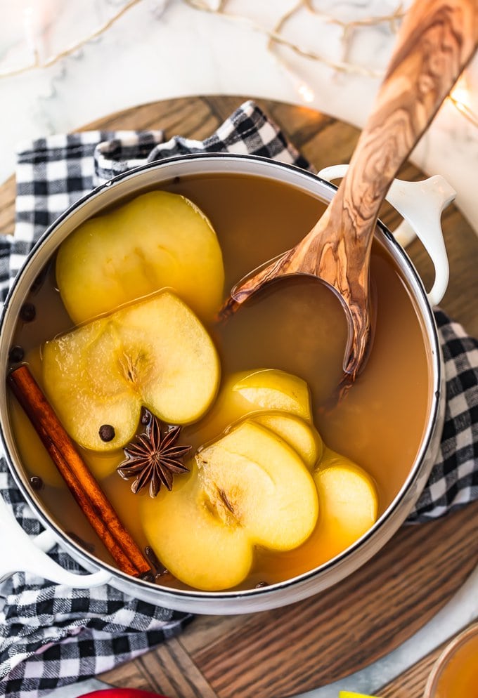 spiced pear cider in a large pot, with sliced pears and spices floating on top