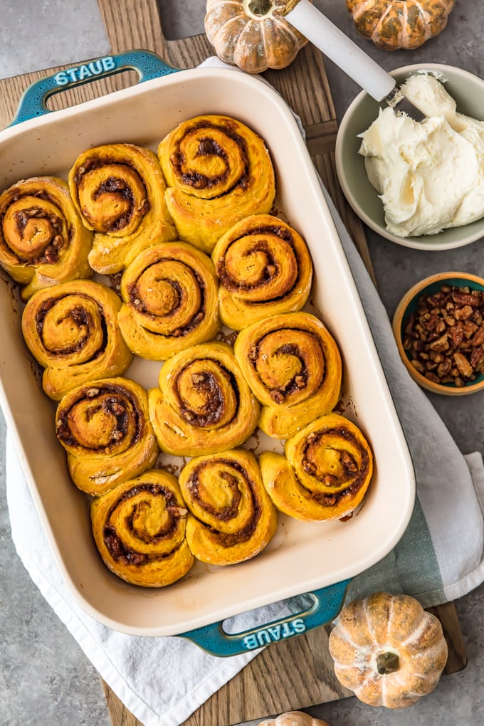 Overhead shot of pumpkin cinnamon rolls in a baking pan