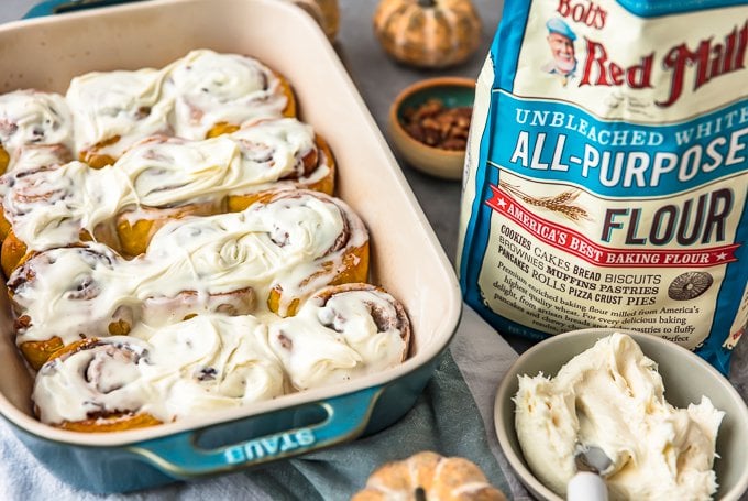 Pumpkin cinnamon rolls from scratch in a blue baking dish