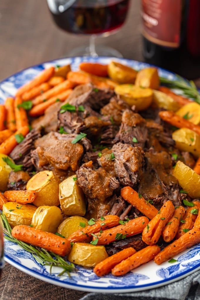 a serving platter filled with pot roast and veggies