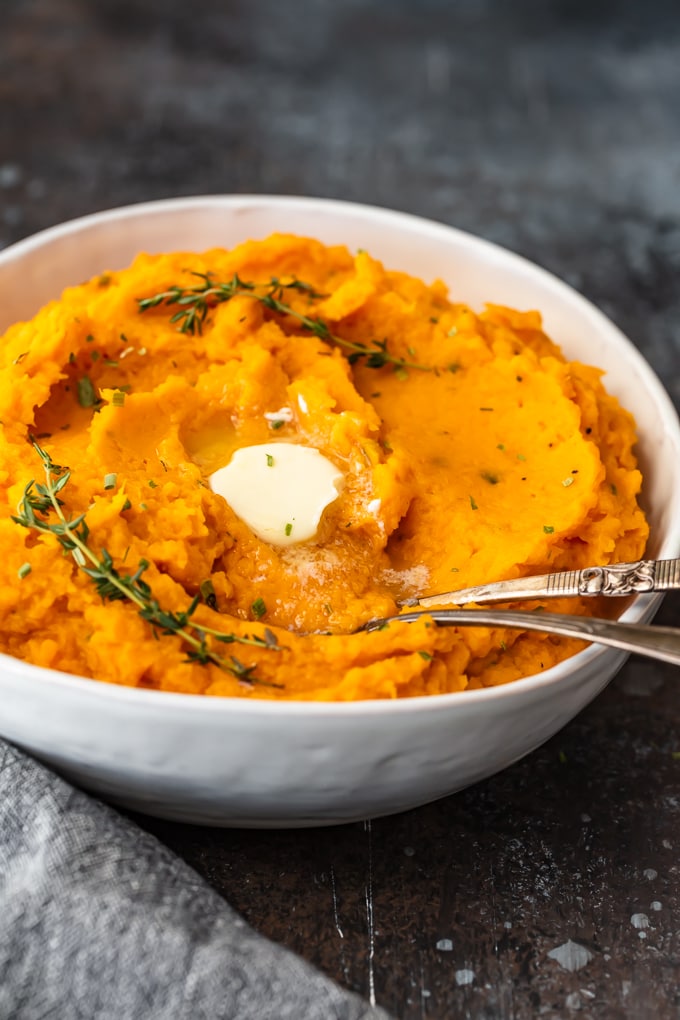 Savory mashed sweet potatoes in a white bowl
