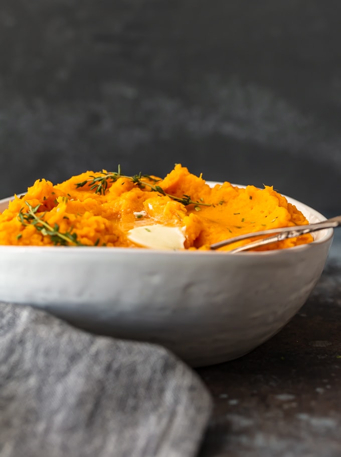 mashed sweet potatoes in a white bowl, viewed from the side